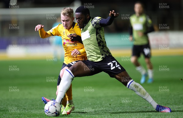 220422 - Newport County v Colchester United, Sky Bet League 2 - Oliver Cooper of Newport County is tackled by Junior Tchamadeu of Colchester United