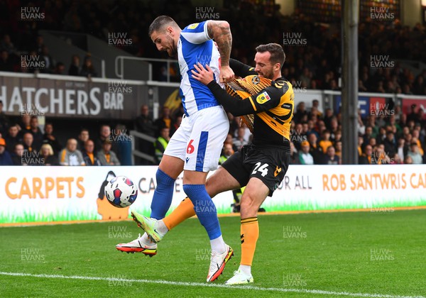 221022 - Newport County v Colchester United - EFL SkyBet League 2 - Tom Dallison of Colchester United is tackled by Aaron Wildig of Newport County
