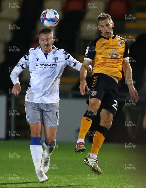 271020 - Newport County v Colchester United - SkyBet League Two - Luke Norris Colchester United and Mickey Demetriou of Newport County go up for the ball