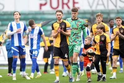 070326 - Newport County v Colchester United - Sky Bet League 2 - Matthew Baker of Newport County leads the teams out
