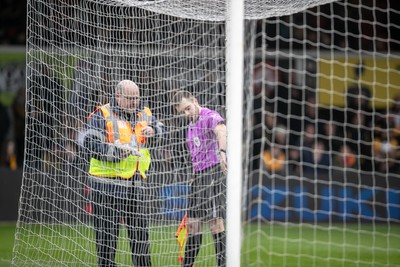 070326 - Newport County v Colchester United - Sky Bet League 2 - Officials inspect one of the nets which delayed kick off