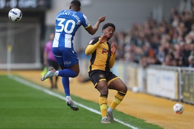 070326 - Newport County v Colchester United - Sky Bet League 2 - Kane Vincent-Young of Colchester United wins a header against Bobby Kamwa of Newport County