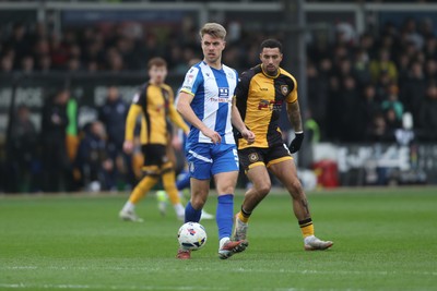 070326 - Newport County v Colchester United - Sky Bet League 2 - Jack Tucker of Colchester United plays the ball to his keeper under pressure from Courtney Baker-Richardson of Newport County