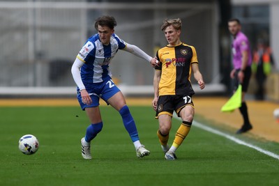 070326 - Newport County v Colchester United - Sky Bet League 2 - Tom Davies of Newport County plays the ball past Finley Barbrook of Colchester United 