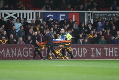 070326 - Newport County v Colchester United - Sky Bet League 2 - Micah Mbick of Colchester United is stretchered off