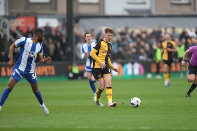 070326 - Newport County v Colchester United - Sky Bet League 2 - Gerard Garner of Newport County threads a pass through past Kane Vincent-Young of Colchester United 