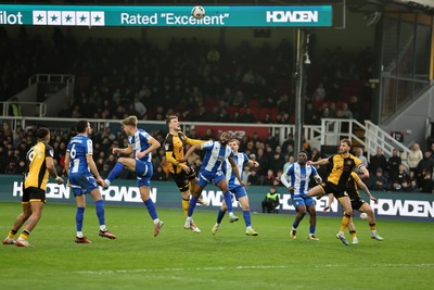 070326 - Newport County v Colchester United - Sky Bet League 2 - Players challenge for a high ball in the Colchester box 