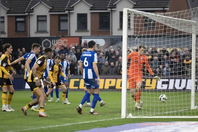070326 - Newport County v Colchester United - Sky Bet League 2 - Players watch as the ball hits the Colchester post