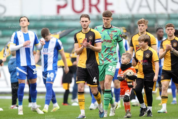 070326 - Newport County v Colchester United - Sky Bet League 2 - Matthew Baker of Newport County leads the teams out