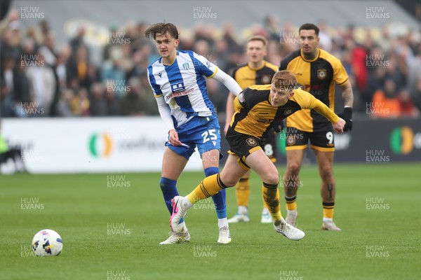 070326 - Newport County v Colchester United - Sky Bet League 2 - Finley Barbrook of Colchester United wins the ball from Gerard Garner of Newport County