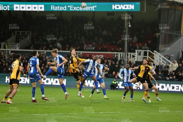 070326 - Newport County v Colchester United - Sky Bet League 2 - Players challenge for a high ball in the Colchester box 