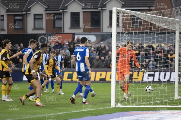 070326 - Newport County v Colchester United - Sky Bet League 2 - Players watch as the ball hits the Colchester post