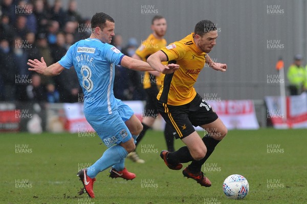 300318 - Newport County v Coventry City - Sky Bet League 2 -  Ben Tozer of Newport County is tackled by Michael Doyle of Coventry City