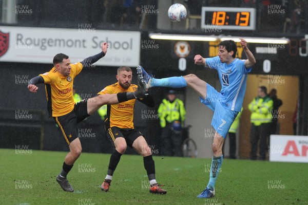 300318 - Newport County v Coventry City - Sky Bet League 2 -  Robbie Willmott of Newport County and Dan Butler of Newport County battle with Peter Vincenti of Coventry City for the ball