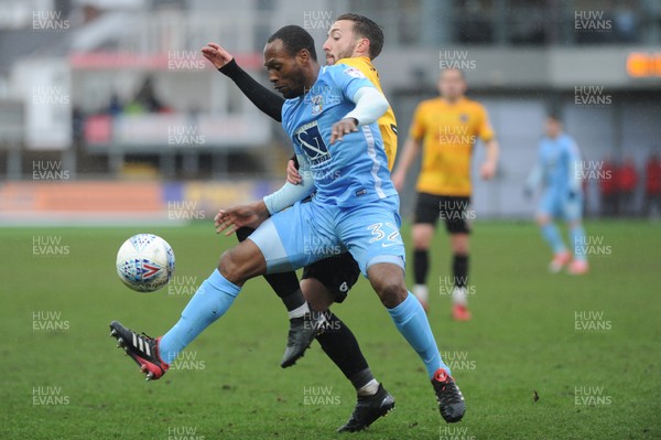 300318 - Newport County v Coventry City - Sky Bet League 2 -  Kyel Reid of Coventry City holds off Joshua Sheehan of Newport County