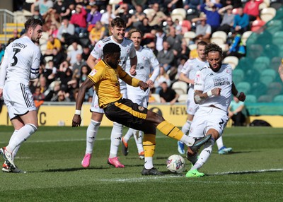 010424 - Newport County v Crawley Town, EFL Sky Bet League 2 - Harry Charsley of Newport County has his shot at goal blocked by Kellan Gordon of Crawley Town