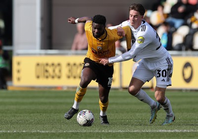 010424 - Newport County v Crawley Town, EFL Sky Bet League 2 - Offrande Zanzala of Newport County is challenged by Will Wright of Crawley Town