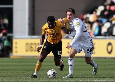 010424 - Newport County v Crawley Town, EFL Sky Bet League 2 - Offrande Zanzala of Newport County is challenged by Will Wright of Crawley Town