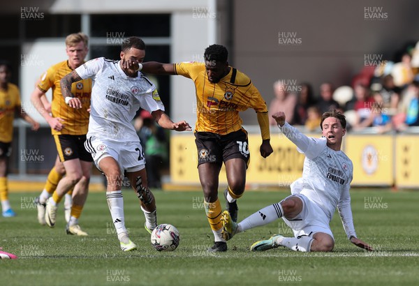 010424 - Newport County v Crawley Town, EFL Sky Bet League 2 - Offrande Zanzala of Newport County is challenged by Will Wright of Crawley Town