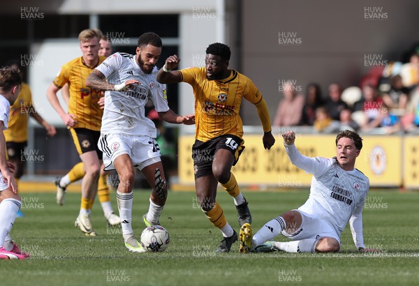 010424 - Newport County v Crawley Town, EFL Sky Bet League 2 - Offrande Zanzala of Newport County is challenged by Will Wright of Crawley Town