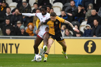 030426 - Newport County v Crawley Town - Sky Bet League 2 - James Crole of Newport County is challenged by Ade Adeyemo of Crawley