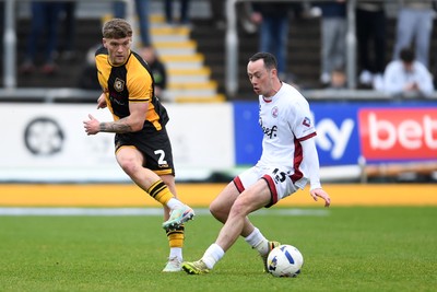 030426 - Newport County v Crawley Town - Sky Bet League 2 - Cameron Evans of Newport County is challenged by Harry McKirdy of Crawley
