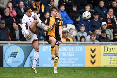 030426 - Newport County v Crawley Town - Sky Bet League 2 - Ben Lloyd of Newport County is challenged by Lewis Richards of Crawley
