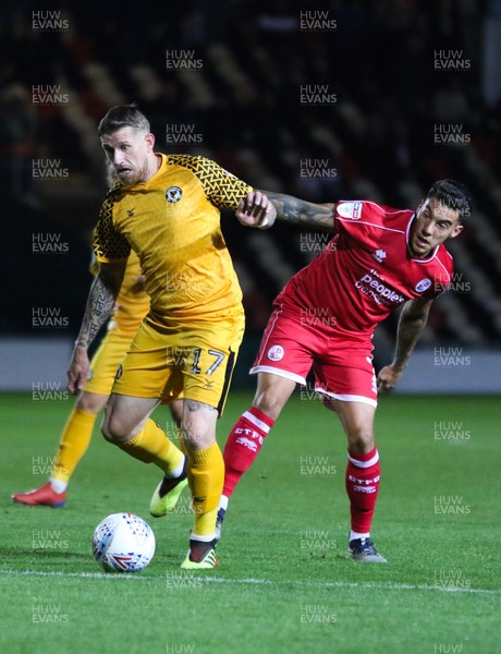 221019 - Newport County v Crawley Town, Sky Bet League 2 - Scot Bennett of Newport County holds off the challenge from Reece Grego-Cox of Crawley Town