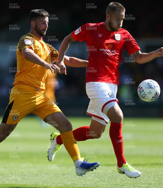 240819 - Newport County v Crewe Alexandra, Sky Bet League 2 - Padraig Amond of Newport County and Olly Lancashire of Crewe Alexandra compete for the ball