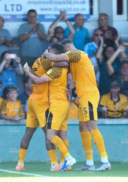 240819 - Newport County v Crewe Alexandra, Sky Bet League 2 - Newport County players celebrate with Padraig Amond after he score a late goal to win the match