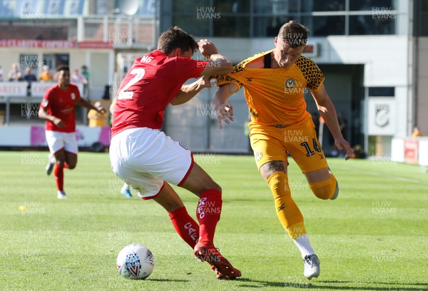 240819 - Newport County v Crewe Alexandra, Sky Bet League 2 - George Nurse of Newport County is held by Perry Ng of Crewe Alexandra