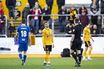 060124 - Newport County v Eastleigh - FA Cup Third Round - Lewis Payne of Newport County receives a yellow card from Referee Ed Duckworth