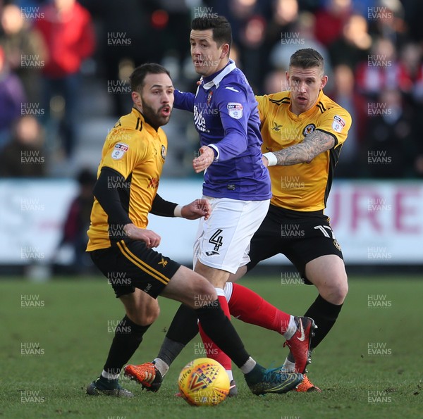 010118 - Newport Count v Exeter City - SkyBet League Two - Lloyd James of Exeter City is tackled by Robbie Willmott and Scot Bennett of Newport County