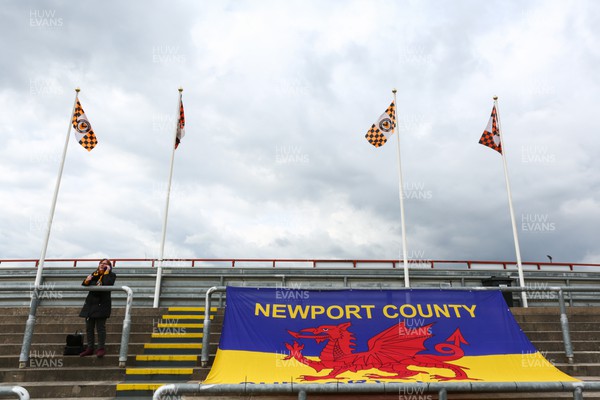 020422 - Newport County v Exeter City - Sky Bet League 2 - Newport County fan stands next to flag in support of Ukraine