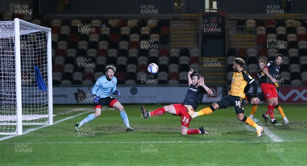 160221 - Newport County v Exeter City, Sky Bet League 2 - Nicky Maynard of Newport County sees his shot blocked by Pierce Sweeney of Exeter City