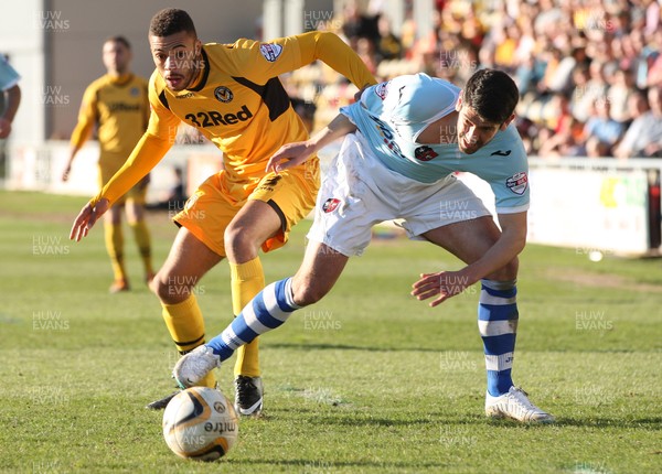 160314 - Newport County v Exeter City, Sky Bet League 2 - Newport's Christian Jolley and Exeter's Danny Butterfield compete for the ball