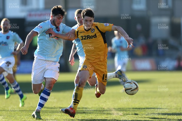 160314 - Newport County v Exeter City, Sky Bet League 2 - Newport's Ryan Burge and Exeter's Jordan Moore-Taylor compete for the ball