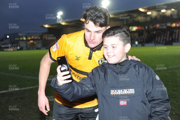 190119 - Newport County v Exeter City - Sky Bet League 2 - Regan Poole of Newport County poses for a photograph with a young fan