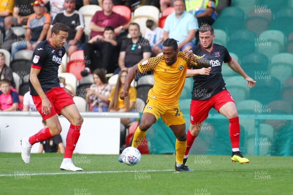210919 Newport County vs Exeter City - Sky Bet League 2 - Dominic Poleon of Newport County takes on Aaron Martin(L) and Pierce Sweeney of Exeter City 