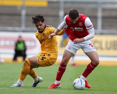 120926 - Newport County v Fleetwood Town - Sky Bet League 2 - Matt Dibley-Dias of Newport County challenges Mark Helm of Fleetwood Town for the ball