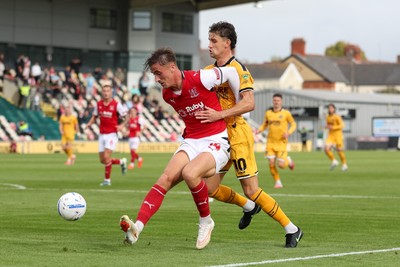120926 - Newport County v Fleetwood Town - Sky Bet League 2 - Lewis McCann of Fleetwood Town attempts to stop Harrison Biggins of Newport County from getting to the ball