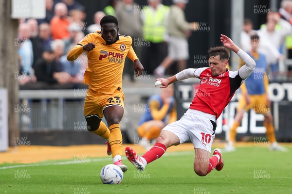 120926 - Newport County v Fleetwood Town - Sky Bet League 2 - Mark Helm of Fleetwood Town fouls Michael Adu-Poku of Newport County