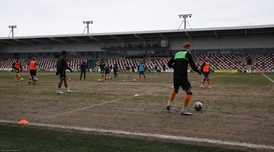 210221 Newport County v Forest Green Rovers, Sky Bet League 2 - Newport County warm up ahead of the match on a very heavy pitch