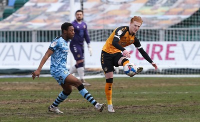 210221 Newport County v Forest Green Rovers, Sky Bet League 2 - Ryan Haynes of Newport County plays the ball forward as Ebrima Adams of Forest Green Rovers challenges