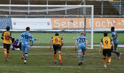 210221 Newport County v Forest Green Rovers, Sky Bet League 2 - Jamille Matt of Forest Green Rovers, right, scores the second goal as he puts the penalty shot past Newport County goalkeeper Nick Townsend
