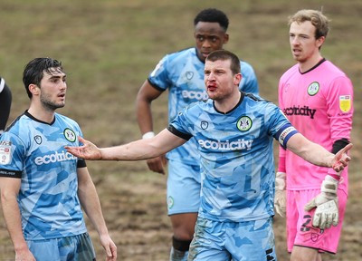 210221 Newport County v Forest Green Rovers, Sky Bet League 2 - Chris Stokes of Forest Green Rovers reacts after being hit in the face by Ryan Taylor of Newport County as competed for the ball