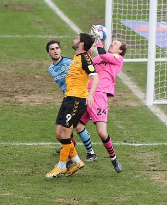 210221 Newport County v Forest Green Rovers, Sky Bet League 2 - Forest Green Rovers goalkeeper Lewis Thomas takes the ball as Padraig Amond of Newport County challenges