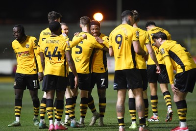 040325 - Newport County v Gillingham - Sky Bet League 2 - Bobby Kamwa of Newport County celebrates scoring his second goal of the match with team mates