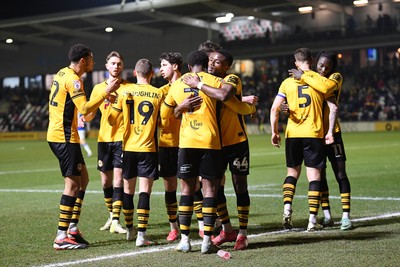 040325 - Newport County v Gillingham - Sky Bet League 2 - Bobby Kamwa of Newport County celebrates scoring his third goal with team mates and completes his first half hat-trick 