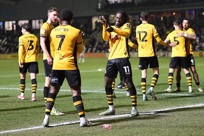 040325 - Newport County v Gillingham - Sky Bet League 2 - Bobby Kamwa of Newport County celebrates scoring his third goal with team mates and completes his first half hat-trick 